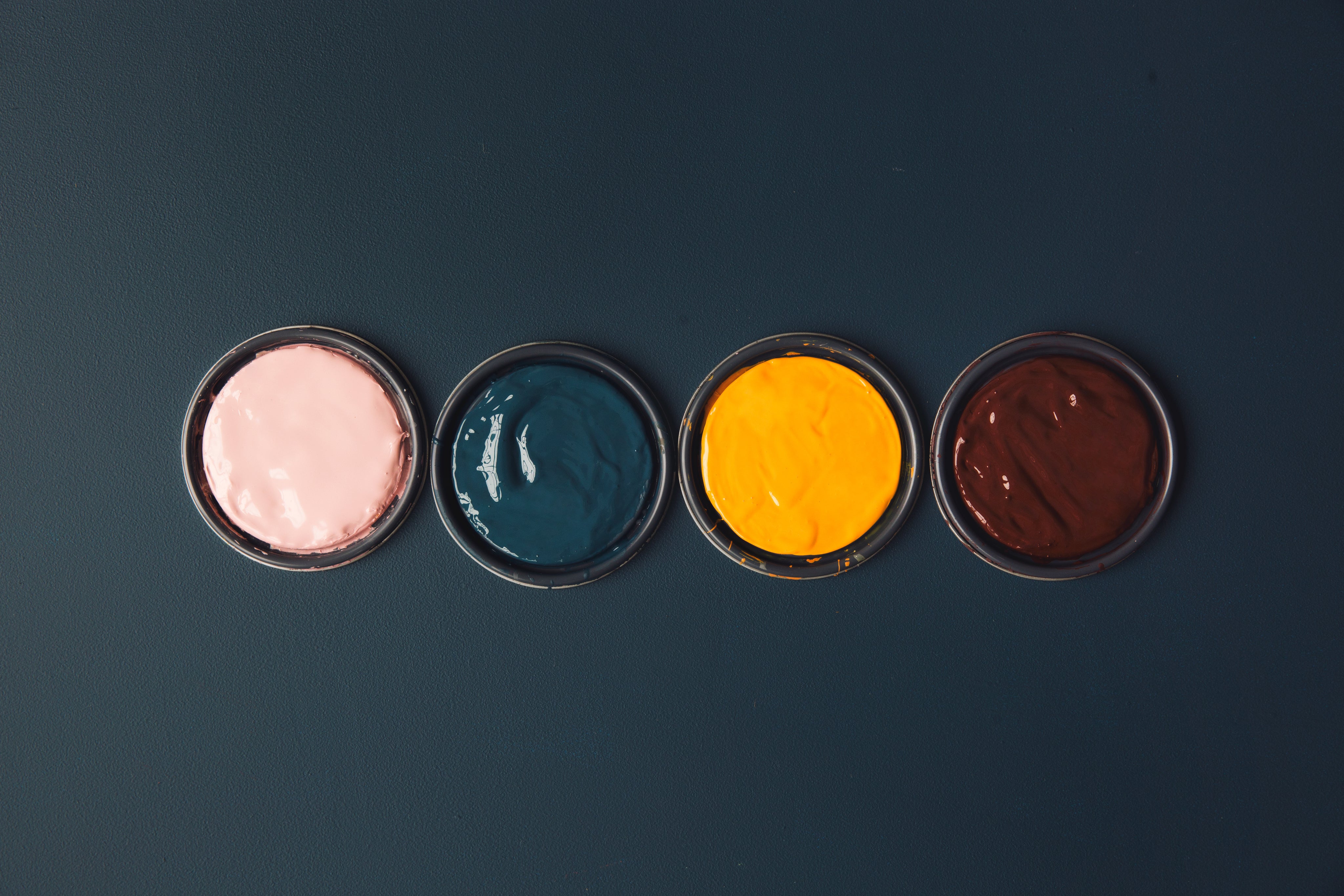 vibrant-pots-of-paints-on-a-blue-table.jpg